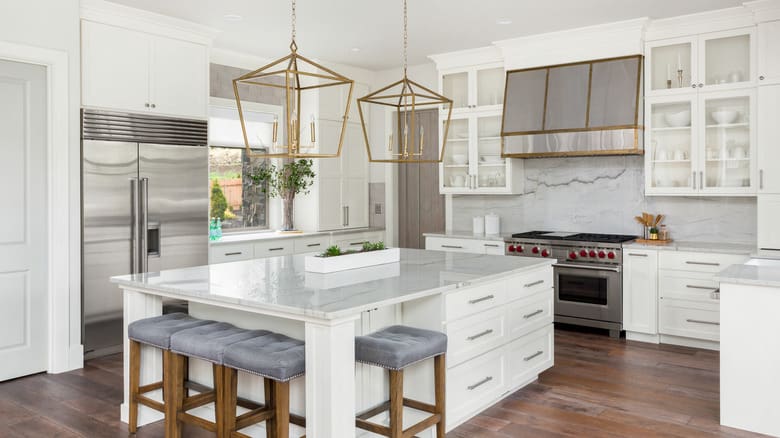 Beautiful Kitchen In New Luxury Home With Island Pendant Lights And Hardwood Floors mixing metal finishes picture